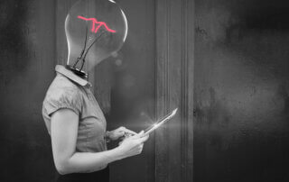women with a lightbulb for a head, holding a tablet
